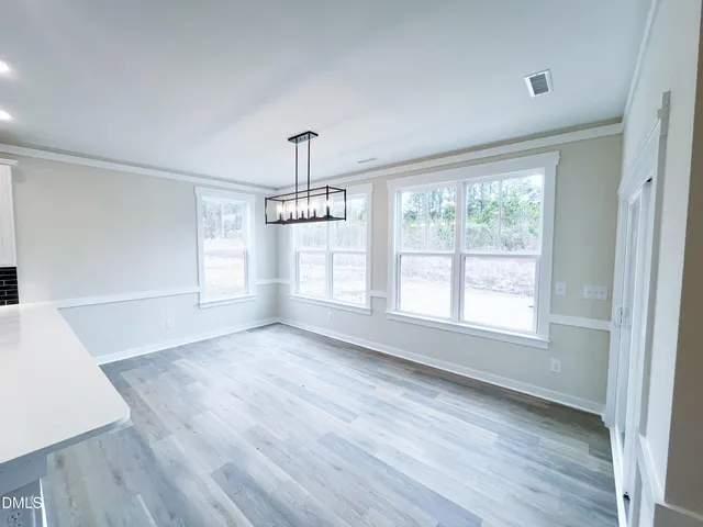 a view of staircase with wooden floor and white walls