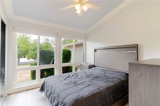 a bedroom with a large bed and a large window