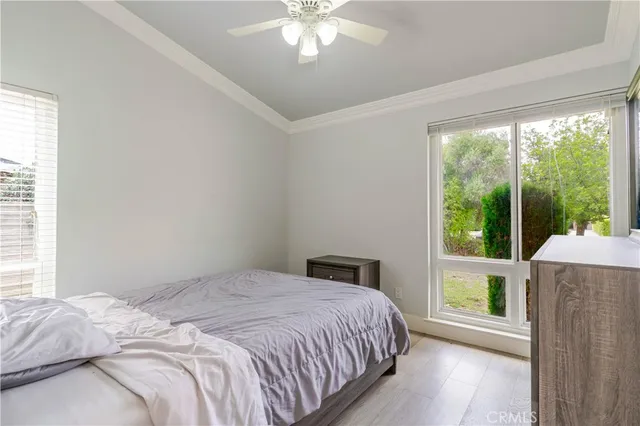 a bedroom with a large bed and a large window