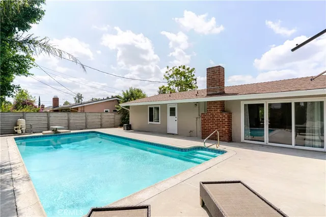 a front view of a house with a garden and yard