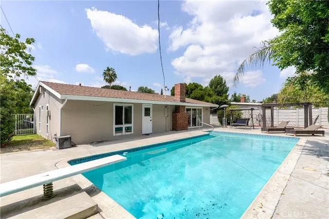 a view of a backyard with sitting area