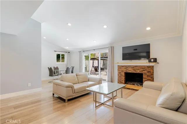 a living room with furniture flat screen tv and a fireplace