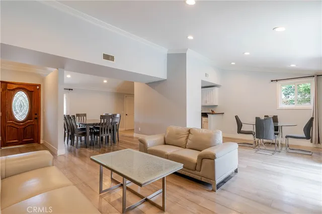 a living room with furniture a dining table and kitchen view