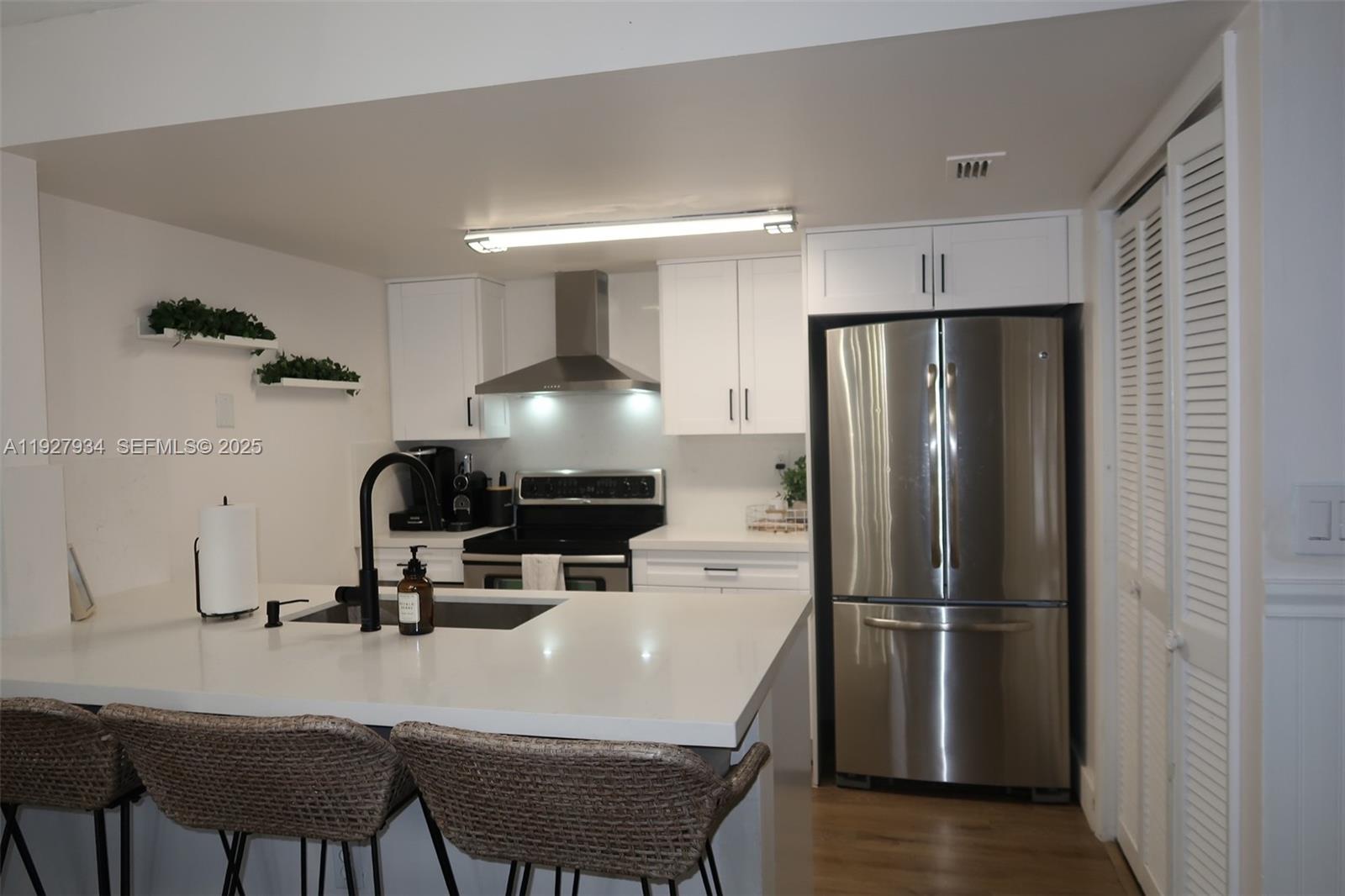 4530 Southwest 68th Ct Circle, Unit 356 Miami, FL 33155 - Photo 12 of 31 a kitchen with stainless steel appliances a refrigerator and a table