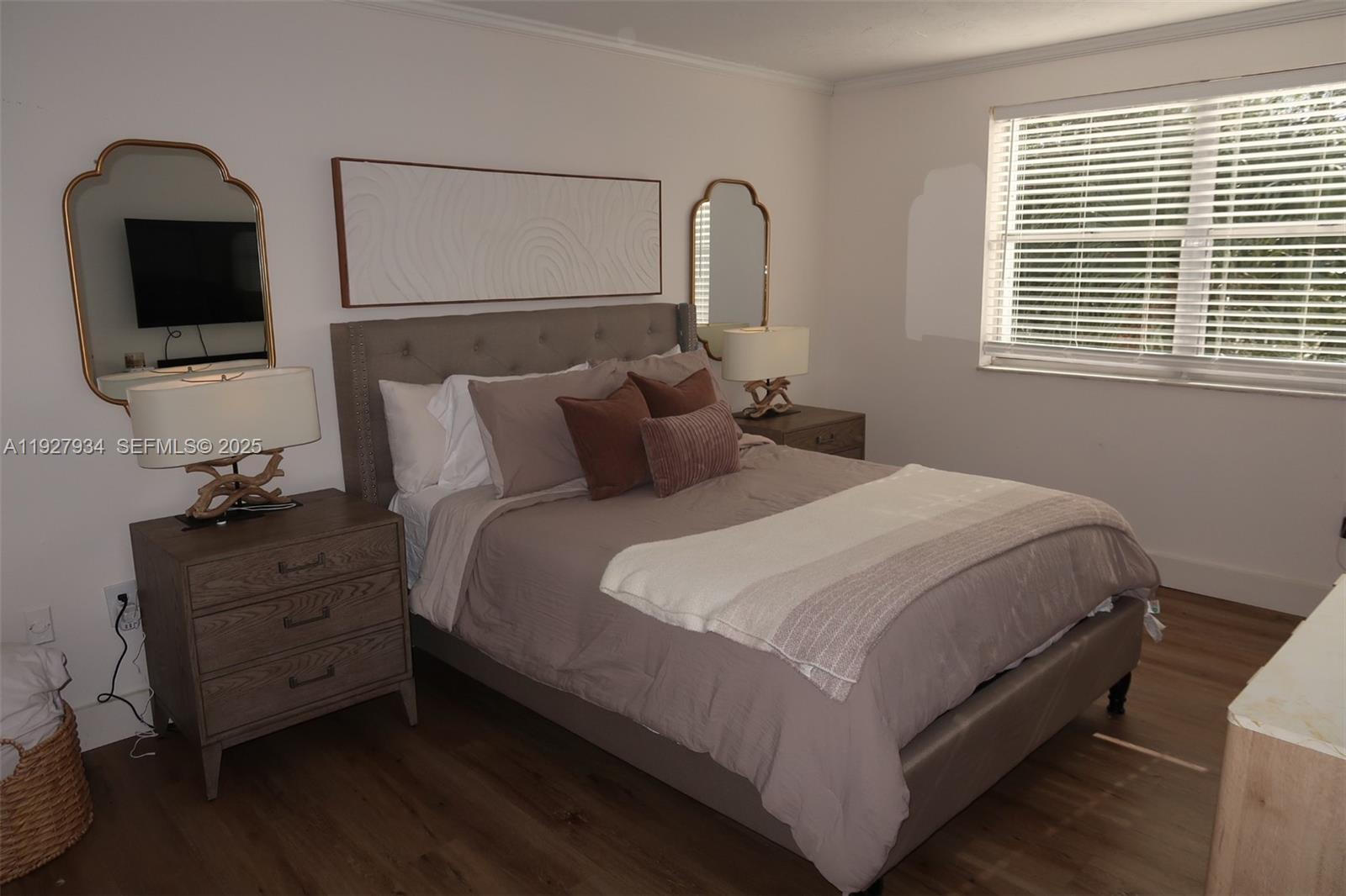 4530 Southwest 68th Ct Circle, Unit 356 Miami, FL 33155 - Photo 23 of 31 a bedroom with a bed and a flat tv screen on a dresser