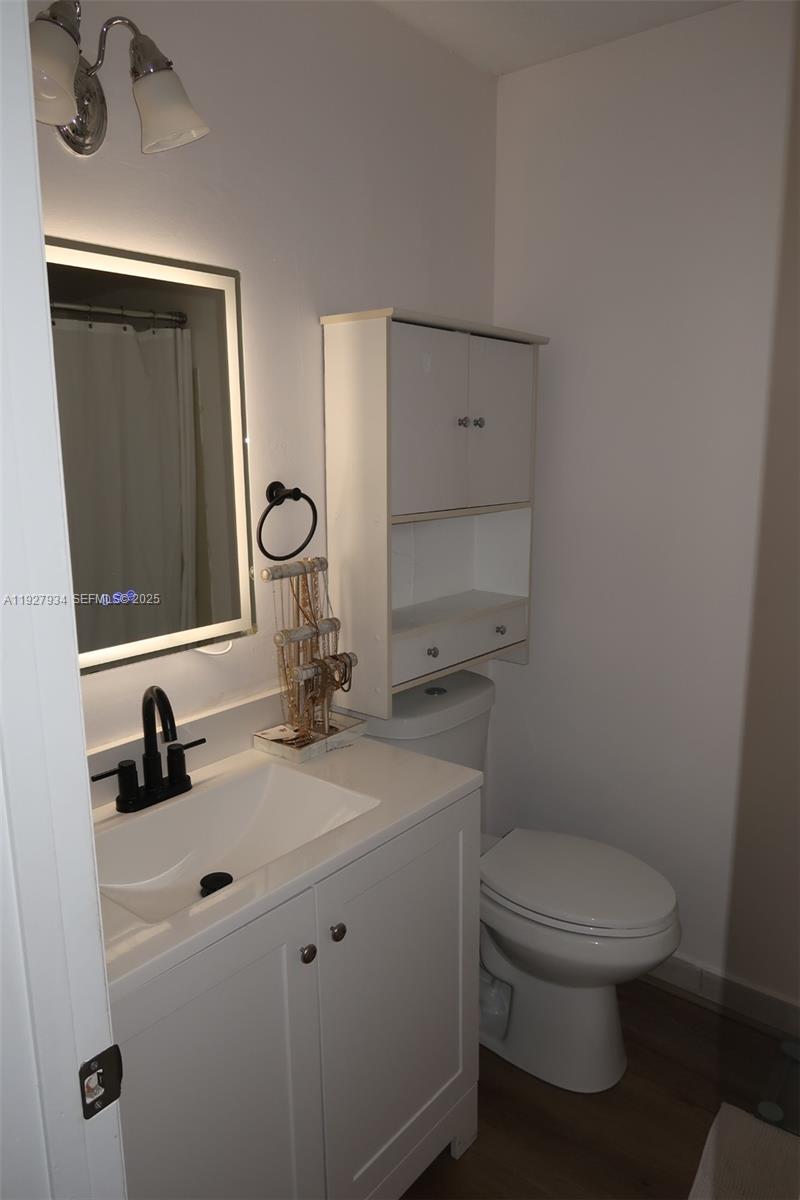4530 Southwest 68th Ct Circle, Unit 356 Miami, FL 33155 - Photo 25 of 31 a bathroom with a toilet sink and mirror