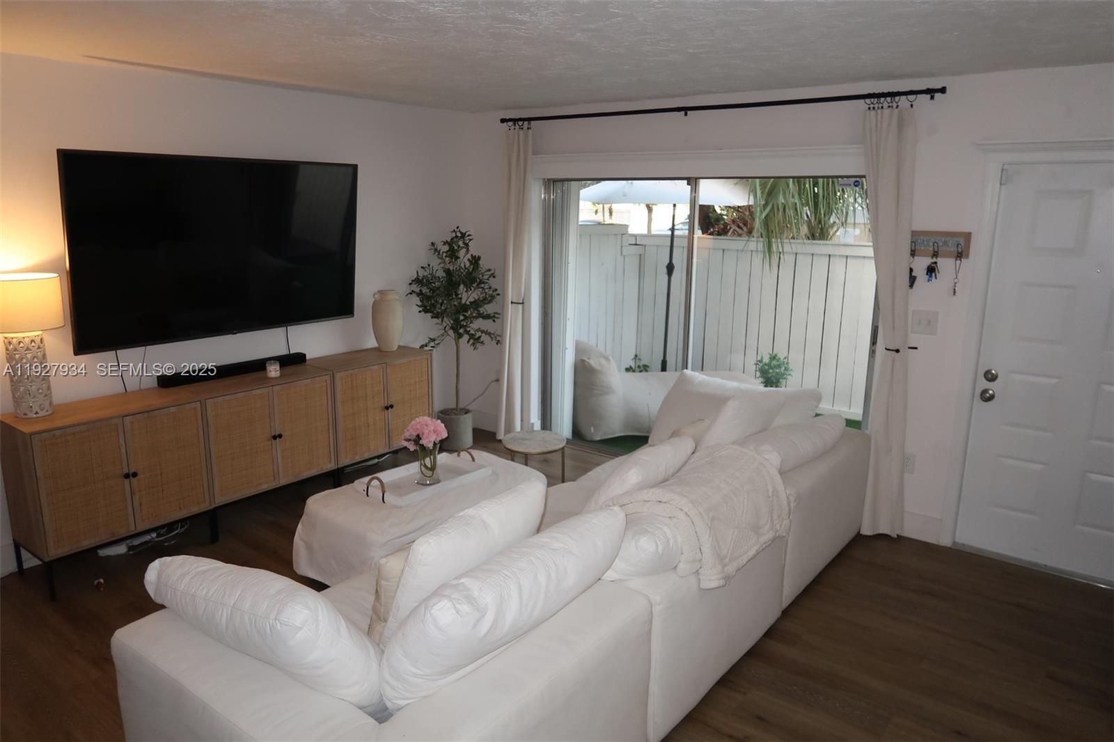 4530 Southwest 68th Ct Circle, Unit 356 Miami, FL 33155 - Photo 6 of 31 a living room with furniture and a flat screen tv