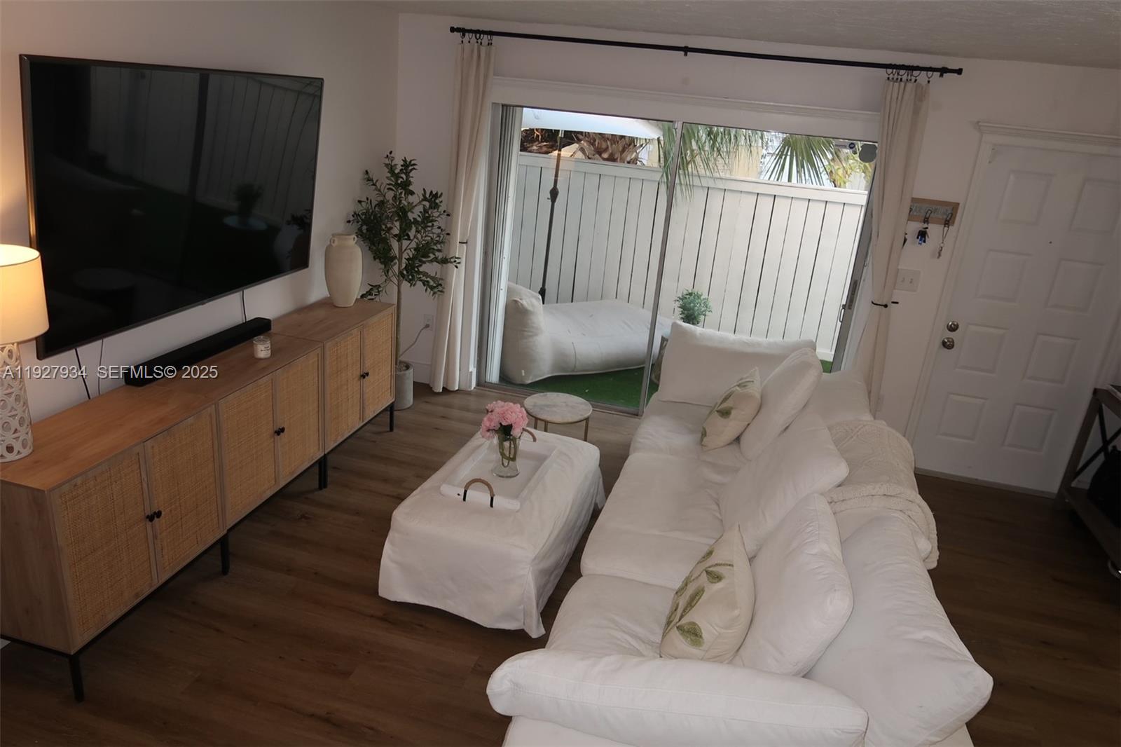 4530 Southwest 68th Ct Circle, Unit 356 Miami, FL 33155 - Photo 7 of 31 a living room with furniture and a flat screen tv