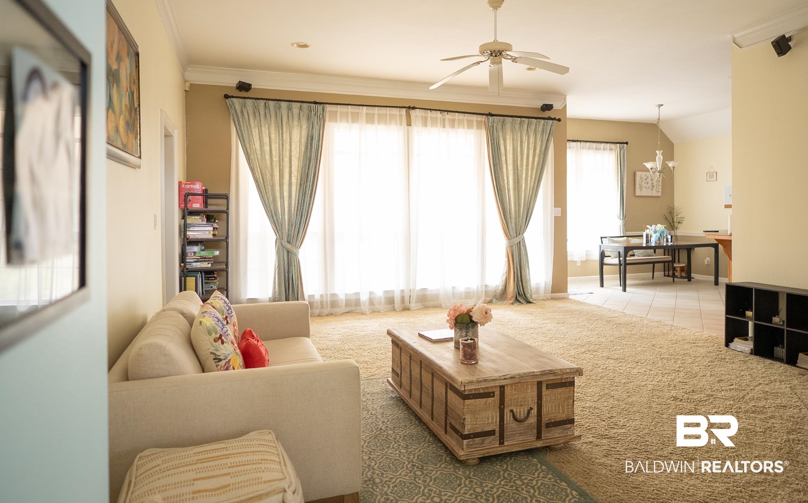 10023 Springfield Court Mobile, AL 36695 - Photo 12 of 50 Living area featuring a ceiling fan, a chandelier, light colored carpet, and ornamental molding
