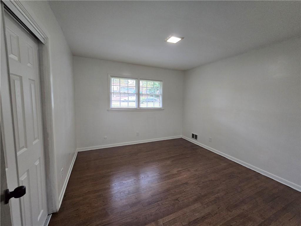 2468 Dresden Drive Northeast Atlanta, GA 30341 - Photo 11 of 26 an empty room with wooden floor and windows