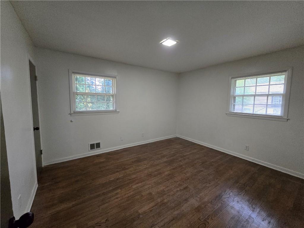 2468 Dresden Drive Northeast Atlanta, GA 30341 - Photo 13 of 26 an empty room with wooden floor and windows