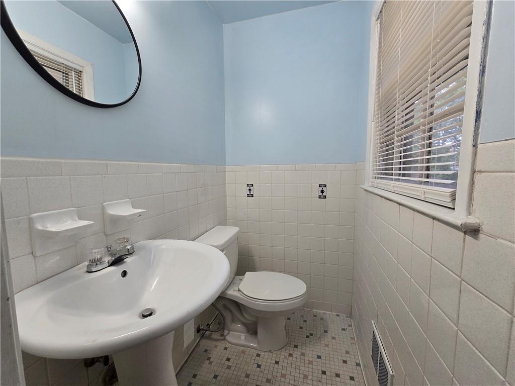 2468 Dresden Drive Northeast Atlanta, GA 30341 - Photo 14 of 26 a bathroom with a sink a toilet and a mirror