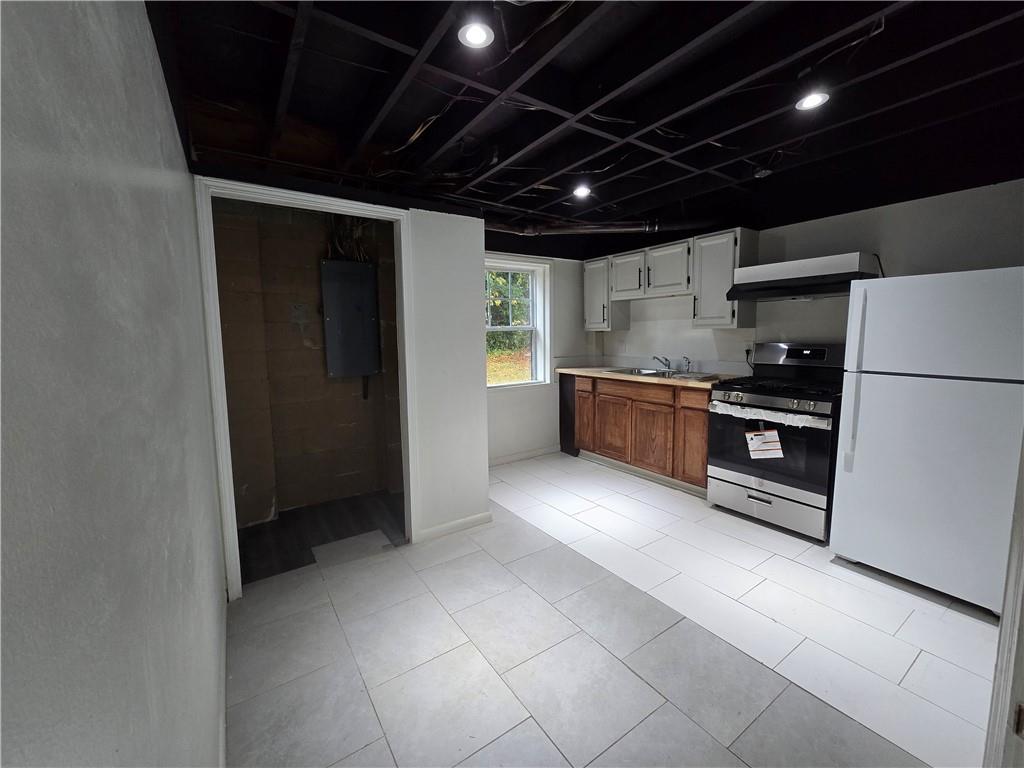 2468 Dresden Drive Northeast Atlanta, GA 30341 - Photo 18 of 26 a large kitchen with stainless steel appliances granite countertop a refrigerator and a stove top oven
