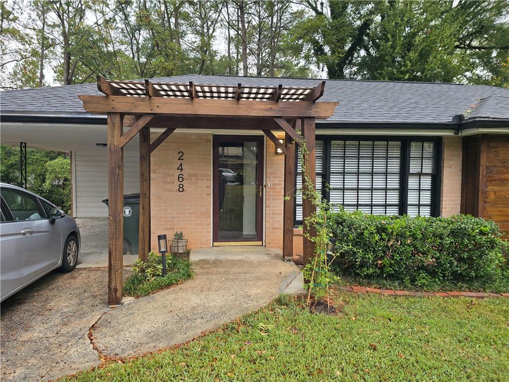 2468 Dresden Drive Northeast Atlanta, GA 30341 - Photo 2 of 26 a view of a house with potted plants and a table and chairs
