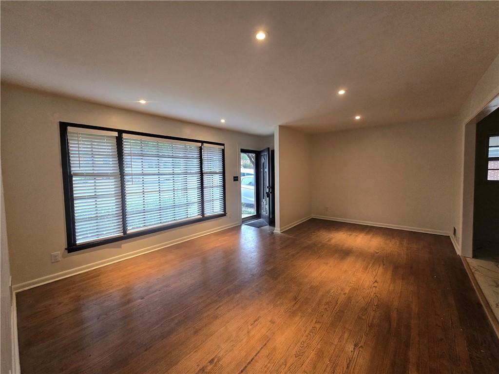 2468 Dresden Drive Northeast Atlanta, GA 30341 - Photo 3 of 26 a view of an empty room with wooden floor and a window