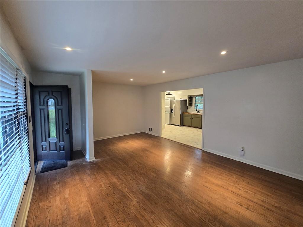 2468 Dresden Drive Northeast Atlanta, GA 30341 - Photo 5 of 26 an empty room with wooden floor and windows