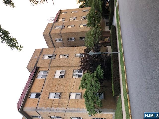 a view of a building next to a yard