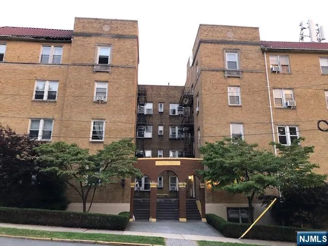 a front view of a building with garden