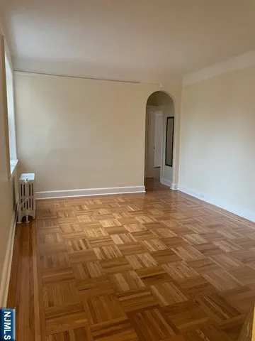 a view of a room with wooden floor and a sink