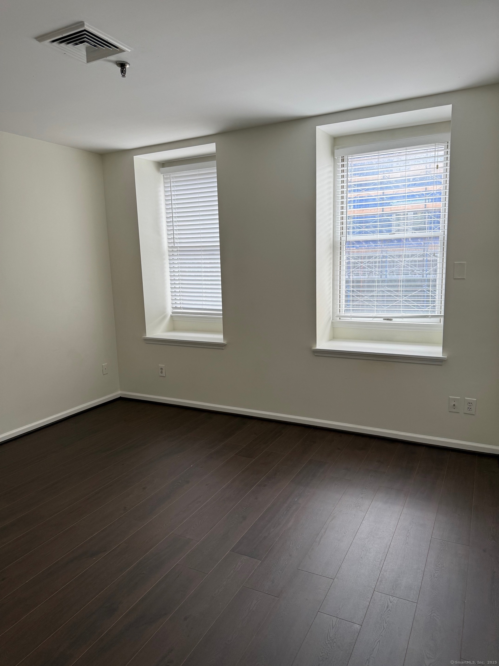 84 Wall Street Norwalk, CT 06850 - Photo 5 of 5 a view of an empty room with wooden floor and a window