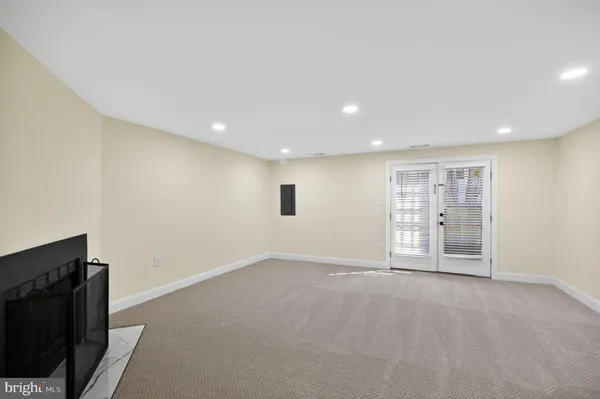 a view of an empty room with a kitchen