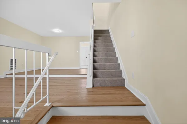 a view of staircase with white walls and windows