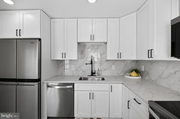 a kitchen with a refrigerator and cabinets