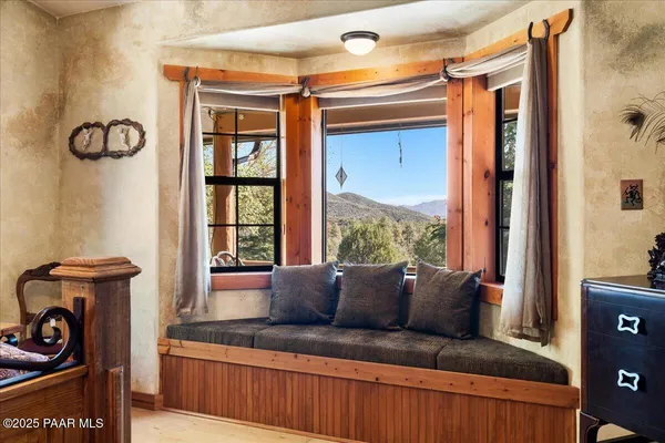 a view of a livingroom with workspace and a window