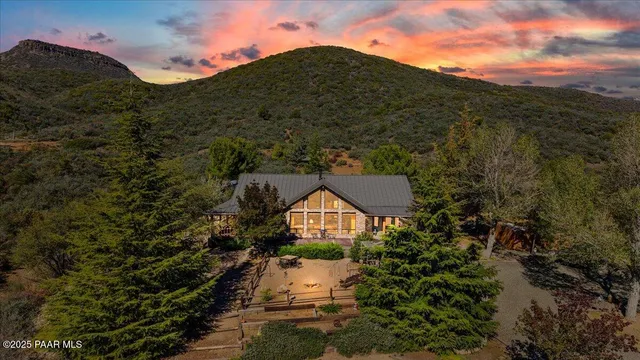 a living room with furniture floor to ceiling window and a table