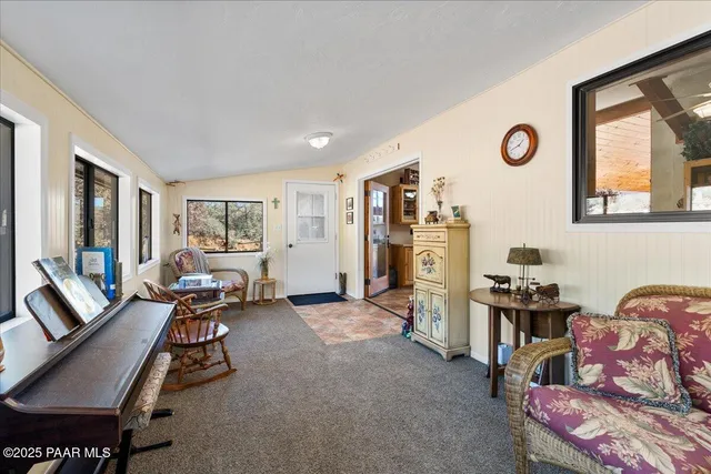 a living room with furniture and a floor to ceiling window