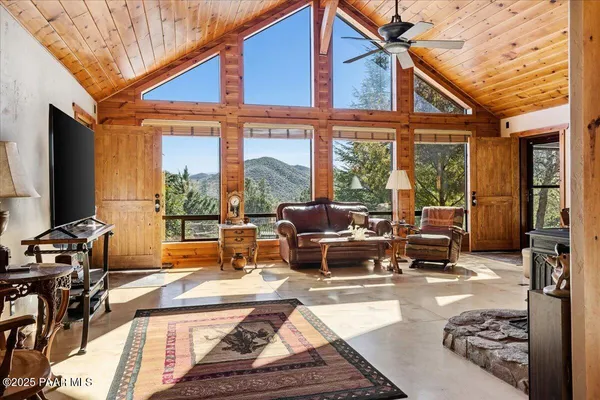 a dining room with stainless steel appliances kitchen island granite countertop a table chairs in it and a window