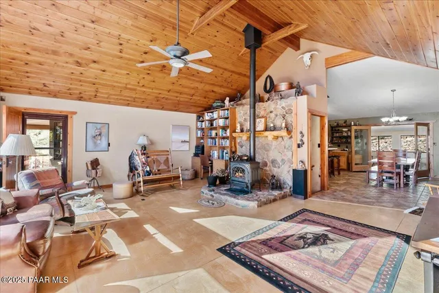 a kitchen with stainless steel appliances granite countertop a stove a refrigerator a oven a dining table and chairs with wooden floor