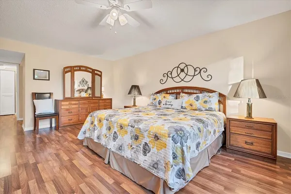 a bedroom with a bed a dresser and chair