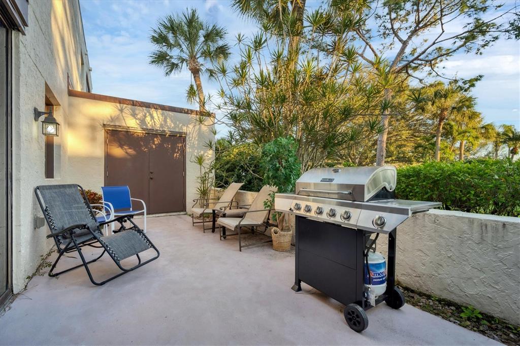 5032 Marsh Field Road, Unit 19 Sarasota, FL 34235 - Photo 23 of 30 a balcony with a bench and some potted plants