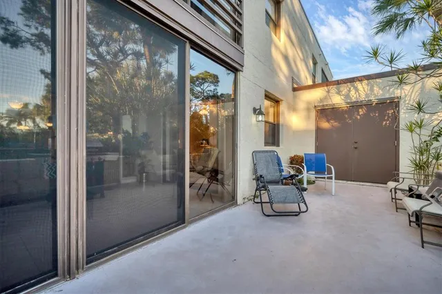 a view of a hallway with chair and front door