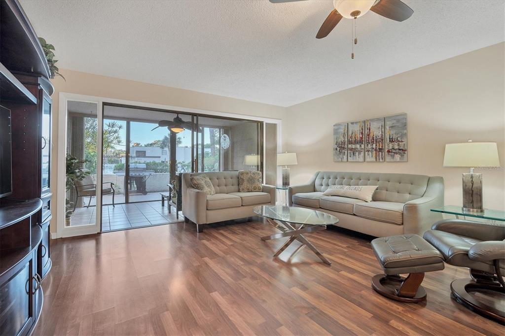 5032 Marsh Field Road, Unit 19 Sarasota, FL 34235 - Photo 5 of 30 a living room with furniture and a flat screen tv
