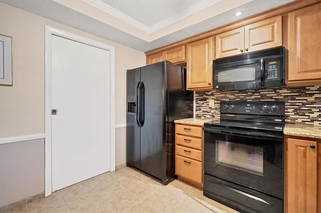 a kitchen with stainless steel appliances granite countertop a refrigerator stove and microwave