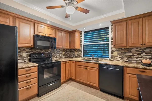 a kitchen with stainless steel appliances granite countertop a sink and cabinets