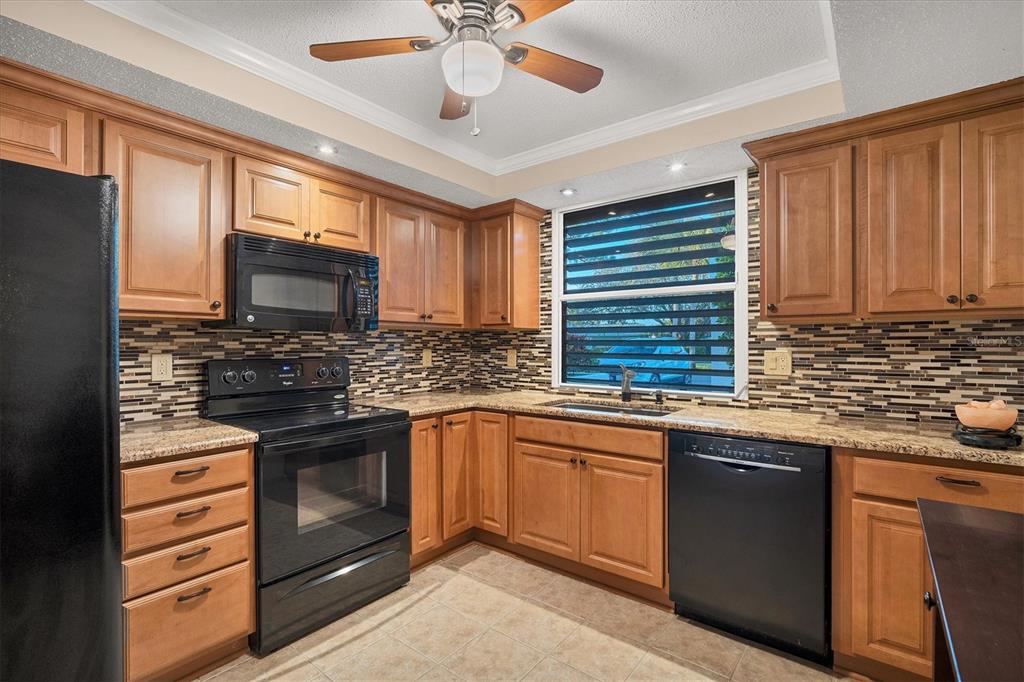 5032 Marsh Field Road, Unit 19 Sarasota, FL 34235 - Photo 10 of 30 a kitchen with stainless steel appliances granite countertop a sink and cabinets