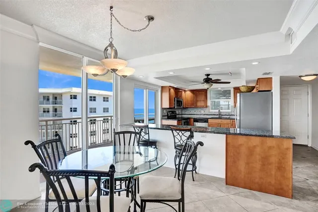 a view of a dining room with furniture and a chandelier