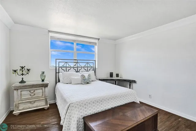 a bedroom with a bed and a potted plant