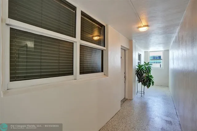 a view of a porch with wooden floor and a potted plant