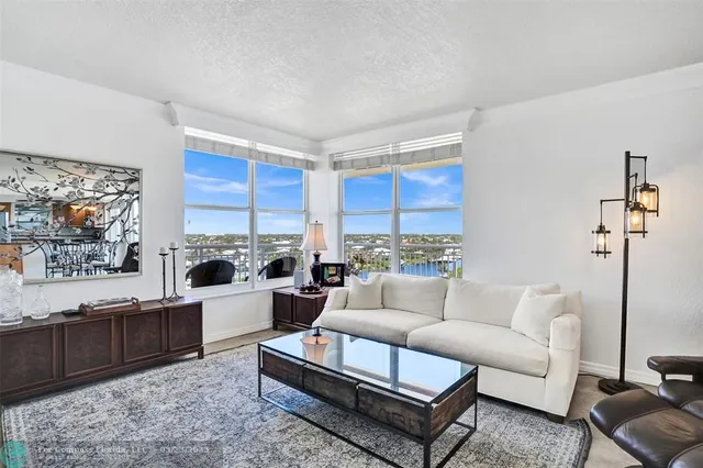 a living room with furniture a rug and a flat screen tv