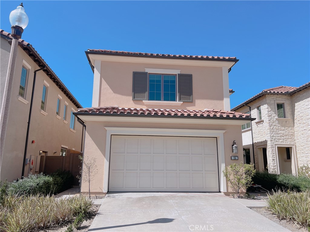 a front view of a house with plants