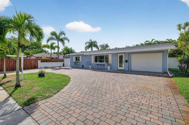 a view of a house with a backyard