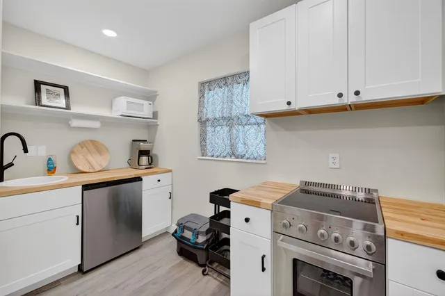 a utility room with sink dryer and washer