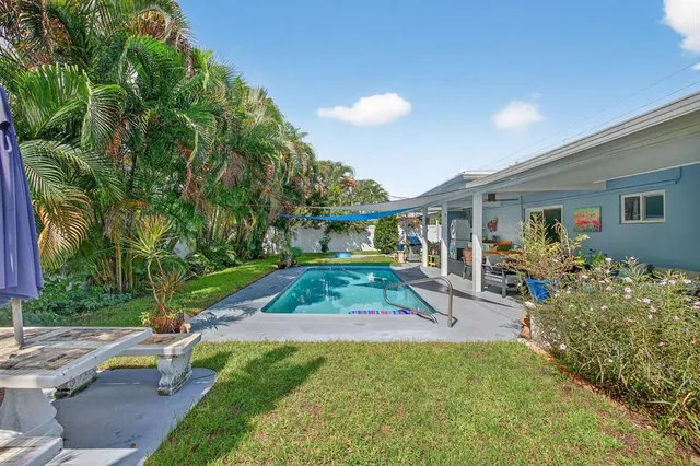 a view of house with swimming pool outdoor seating