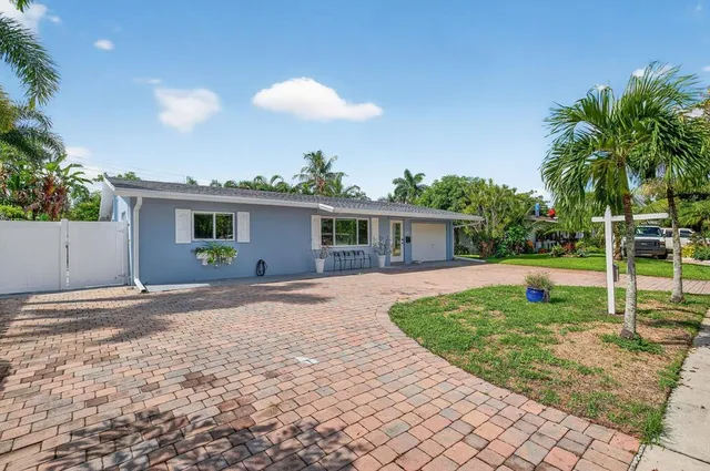 a view of a house with backyard and a tree