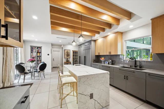 a large kitchen with a table and chairs