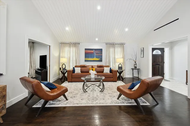 a living room with fireplace furniture and wooden floor